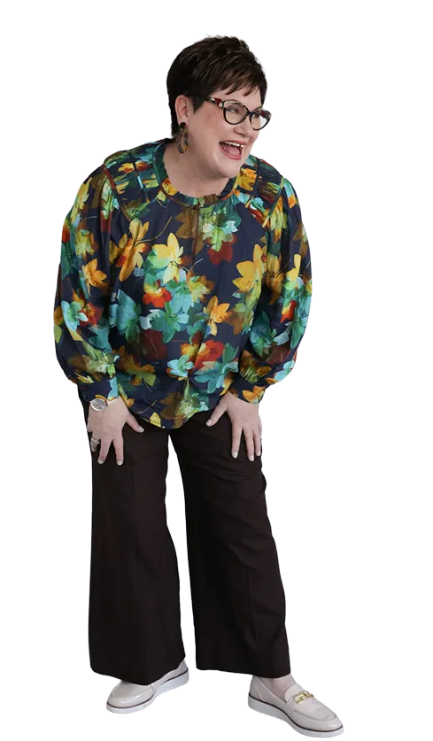 Kerri Price smiling and gesturing to the right.